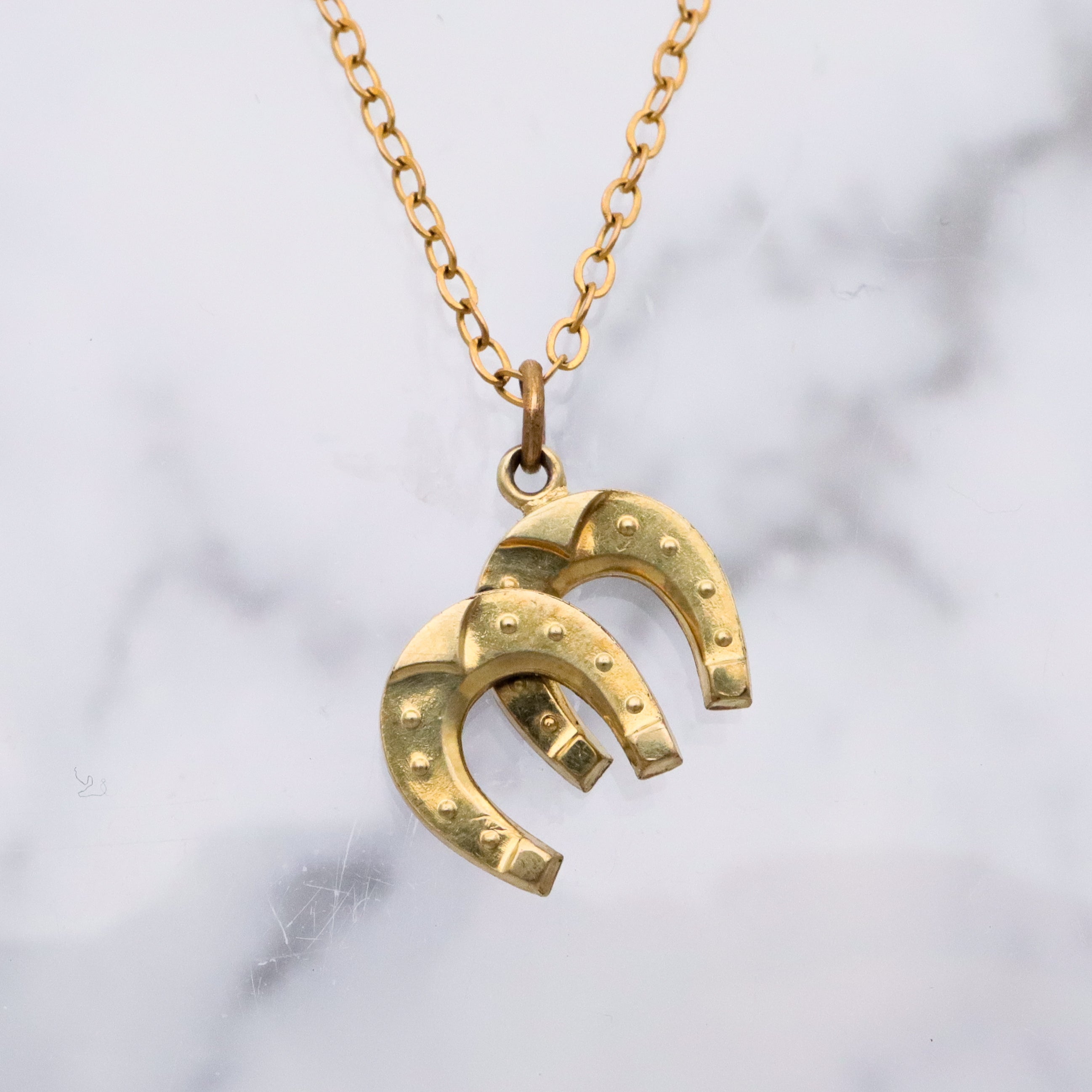 Antique rolled gold double horseshoe lucky charm pendant
